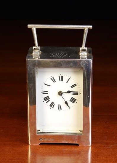 A Cased Silver Carriage Clock by...