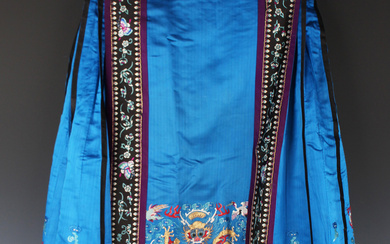 A Chinese blue silk embroidered and pleated apron skirt, late Qing dynasty, the front and back with