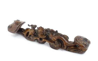 A Chinese carved hardwood ruyi sceptre with dragons and flam...