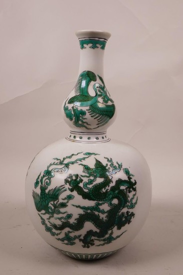 A Chinese double gourd porcelain vase with green enamel drag...