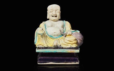 A Chinese glazed biscuit figure of Budai, Kangxi period 素三彩佈袋
