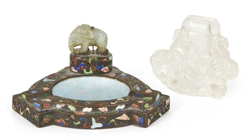 A Chinese rock crystal small vase and cover and a bronze ashtray, early 20th century, the snuff bottle carved in relief with a phoenix amongst bamboo, rockwork and flowering peony blossoms, 7cm high, the ashtray decorated with polychrome enamels...
