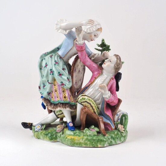 A Derby porcelain figure group, 'The Broken Chair', c.1800-25, depicting a man fallen on a broken chair with brocade behind and a woman with one knee upon a chair and a foot on the ground, both figures in late eighteenth century costume, red enamel...