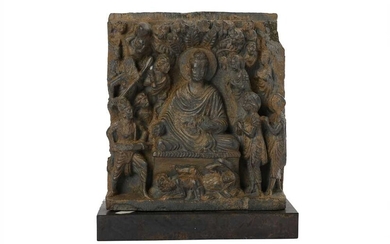 A GREY SCHIST RELIEF OF THE BUDDHA BEING ATTACKED BY MARA Ancient region of Gandhara, 2nd - 3rd century