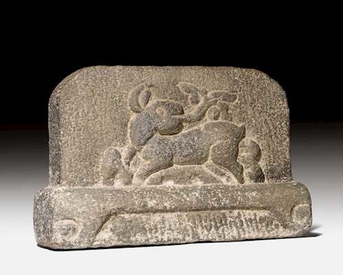 A GREY STONE RELIEF CARVED WITH A RABBIT.