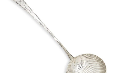 A George III Irish silver ladle, Dublin, c.1790, maker's mark indistinct, the tapering handle with feathered edge to a fluted shell bowl, the handle engraved with a star motif to initialled cartouche (M), 33.5cm long, approx. weight 4.3oz