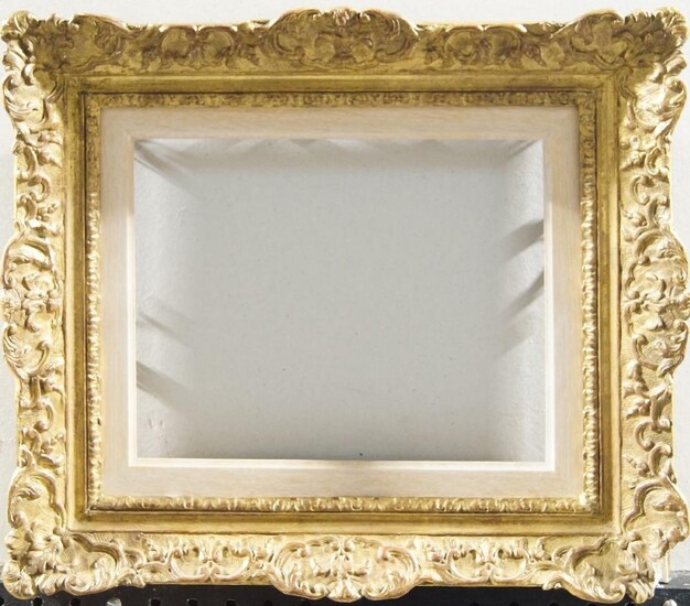 A Gilded Composition Louis XIV Style Frame, early 20th century, with leaf sight, taenia, sanded frieze, the cross-hatched ogee with foliate and flower head strapwork and cartouche centres and corners, 23.5 x 32.5 cm (sight): A Gilded Composition...