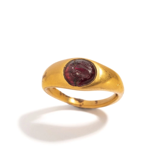 A Greek Gold and Garnet Finger Ring with a Prancing Stag