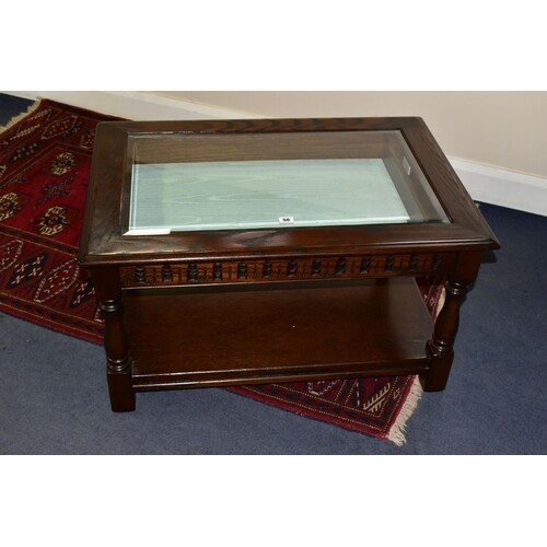 A JAYCEE RECTANGULAR OAK COFFEE TABLE, with a glass bevelled...