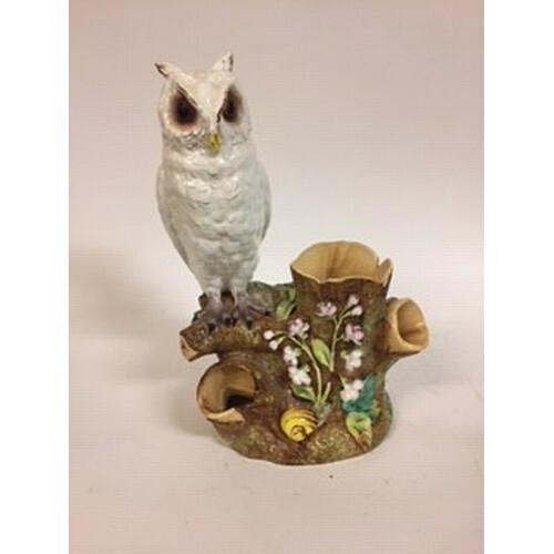 A Moore Brothers figure of a long eared owl, perched on a br...
