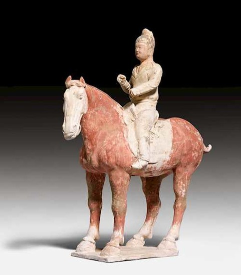 A PAINTED POTTERY FIGURE OF A HORSE AND RIDER.