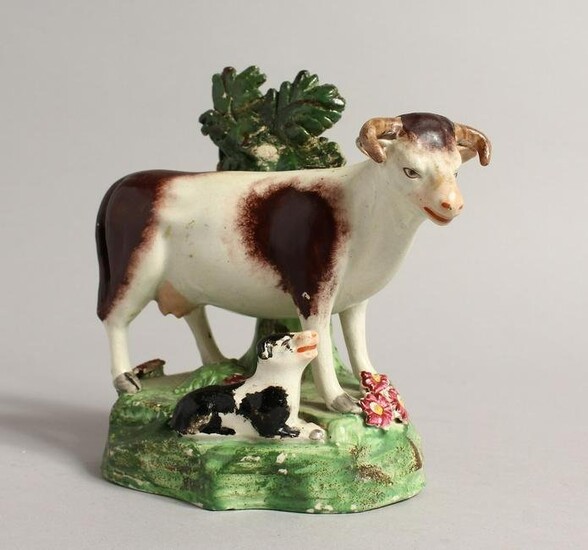A PAIR OF STAFFORDSHIRE BOCAGE GROUPS OF A COW AND CALF