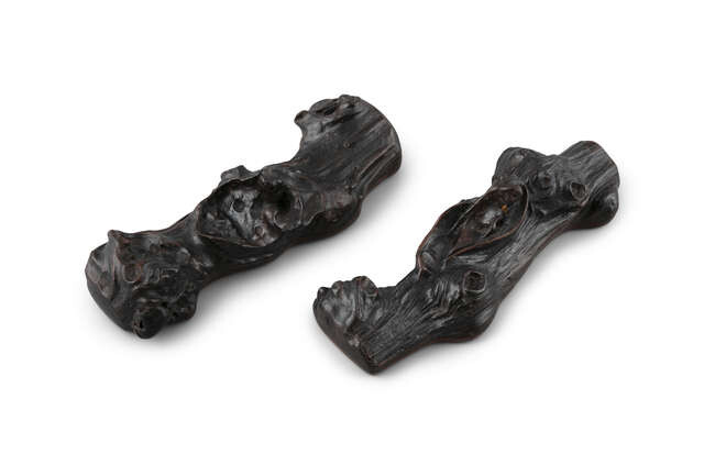 *§A PAIR OF ZITAN ‘BRANCH’ WRISTRESTS OR SCROLLWEIGHTS...