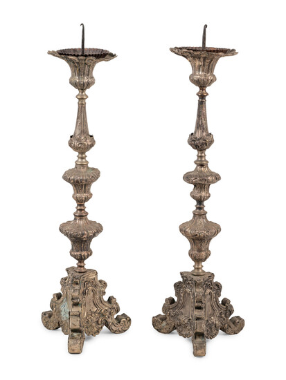 A Pair of Baroque Repoussé Decorated Silvered Metal Pricket Sticks