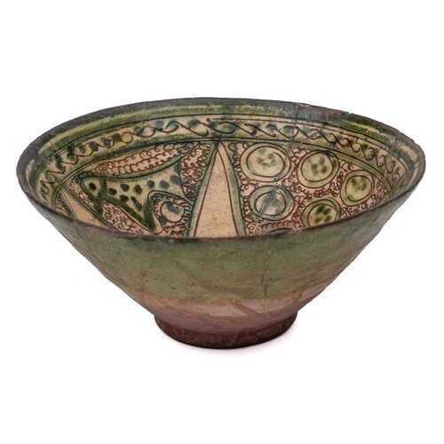 A Persian sgraffito decorated bowl: of conical form the inte...