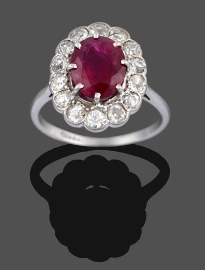 A Ruby and Diamond Cluster Ring, the oval cut ruby...