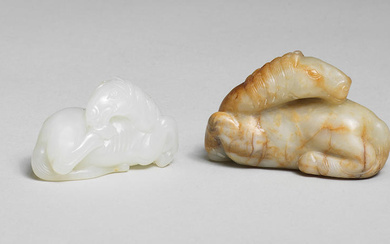 A SMALL WHITE JADE CARVING OF A HORSE AND A...