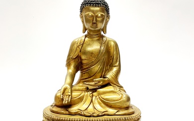 A Sino-Tibetan gilt bronze figure of a seated Buddha H. 38cm