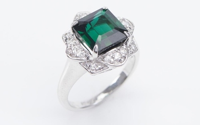 A TOURMALINE AND DIAMOND RING-Centrally set with a square emerald cut green tourmaline weighing 5.00cts, within a floral border of r...
