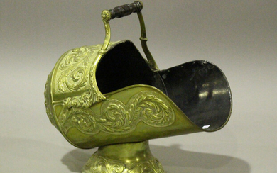 A Victorian brass helmet coal scuttle, embossed with foliate decoration, length 46cm.