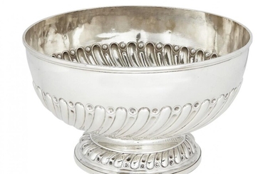 A Victorian silver rose bowl, London, c.1894, Goldsmiths & Silversmiths Co., the part-fluted repousse circular body raised on a round foot decorated with a fluted and roundel decorated band, 18.3cm high, 31.5cm dia., approx. weight 44.6oz
