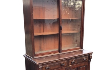 A Victorian stained bookcase cabinet with dentil cornice above a...