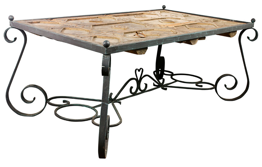 A Wrought iron and distressed wood dining table