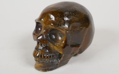 A carved tiger's eye skull, 2½" high
