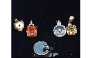 A collection of 9ct gold gem set pendants and a 9ct gold gem...