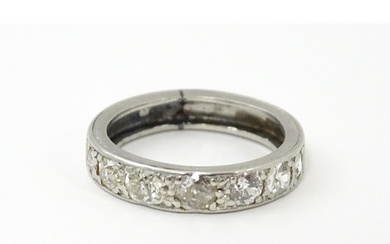A diamond half eternity ring set with 7 diamonds. Ring size ...