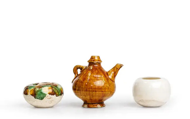 A group of three Chinese miniature vessels Tang dynasty Comprising an amber-glazed...