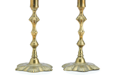A large named pair of English rococo brass candlesticks Stamped...