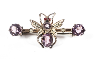 A late 19th/early 20th century unmarked white metal amethyst and seed pearl set brooch