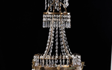 A late Gustavian chandelier, early 19th century, for 4 candles, brass frame, framed with prisms, rings decorated with medusa heads, electrified.