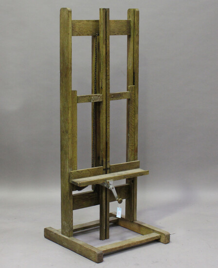 A mid-20th century limed oak artist's easel with chain-driven rising mechanism, height 165cm, w