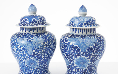 A pair of Chinese porcelain lockurns, early 20th century, baluster-shaped, decoration of lotus loops in underglaze blue, double circle bottom.