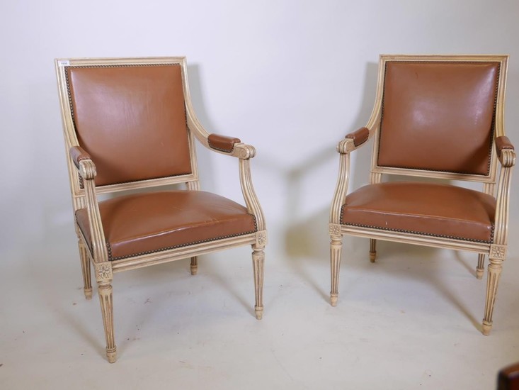 A pair of French style painted open armchairs, with brass st...