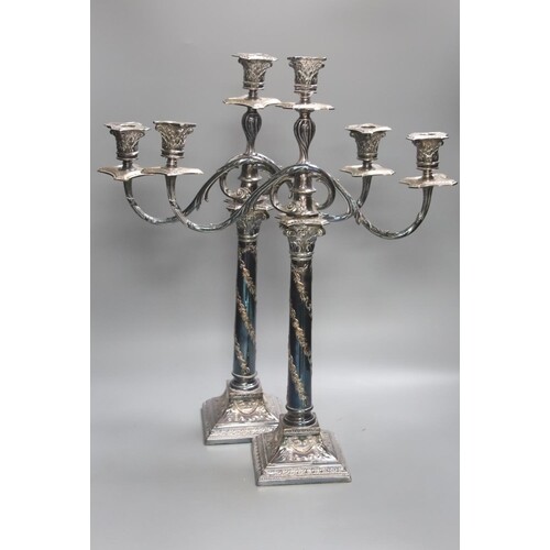A pair of Georgian style plated two-branch three-light cande...