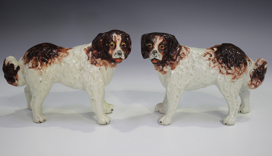 A pair of Staffordshire pottery models of St Bernard dogs, late 19th century, modelled standing with