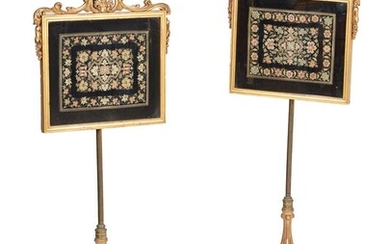 A pair of Victorian giltwood and needlework inset pole screens