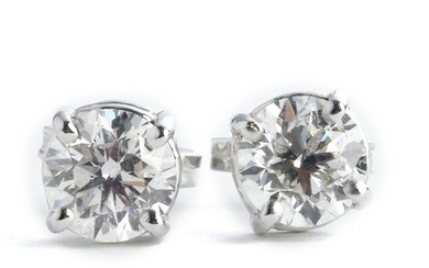 NOT SOLD. A pair of diamond ear studs each set with a brilliant-cut diamond weighing...