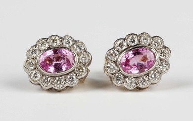 A pair of gold, pink sapphire and diamond oval cluster earstuds, each collet set with an oval cut pi