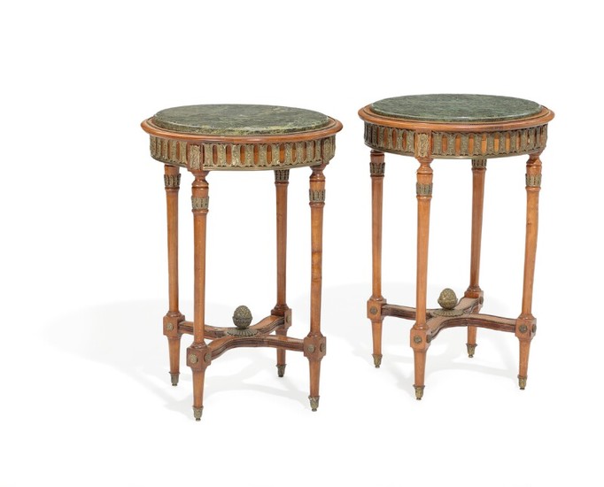 A pair of stained beech lamp tables, decorated with bronze mountings, green marble tops. 20th century. H. 75. Diam. 53 cm. (2)