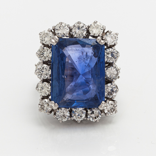 A platinum ring with a ca. 18.00 ct sapphire and ca. 3.00 cts of diamonds. With certificates.