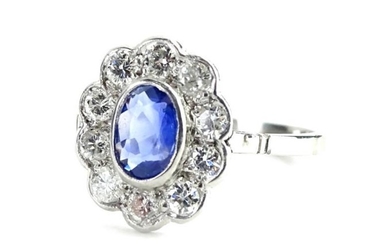A sapphire and diamond cluster ring, with central oval...