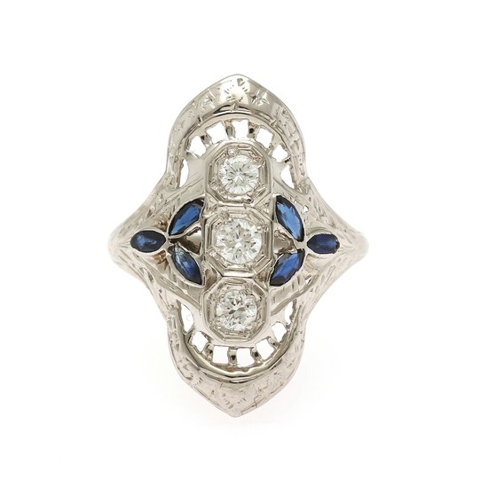 A sapphire and diamond ring set with six marquise-cut sapphires and three brilliant-cut diamonds, mounted in 18k white gold. Size 49.