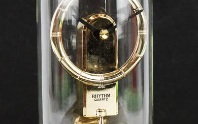 A stylish Quartz 'Rhythm' (Tokyo) gold tone glass dome clock,...