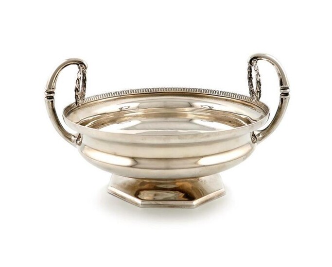 A two-handle silver bowl, by Mappin and Webb, Birmingham 1914. circular bowl, gadroon border, with flying scroll handles with hanging laurel wreathes, on a raised octagonal foot, length handle to handle 26cm, approx. weight 27.5oz.