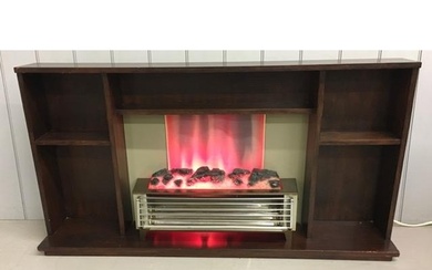 A vintage fire surround, with integrated electric heater. Di...