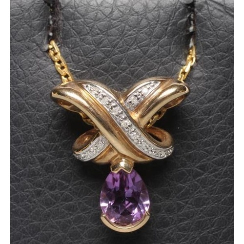 AN AMETHYST AND DIAMOND PENDANT, the oval facet cut amethyst...